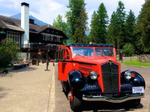 The red tour buses are things to do in glacier national park with kids.