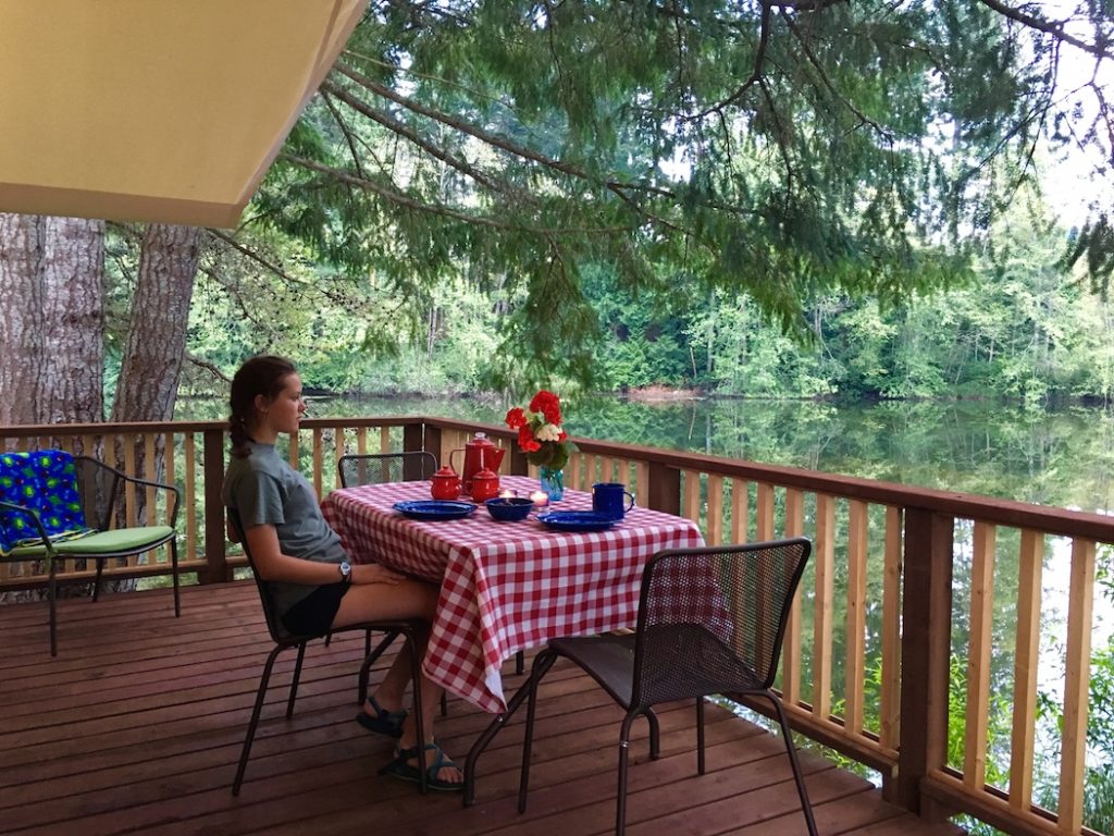 Enjoy the deck of the Canvas Cottage, one of the best places to camp with kids in Washington. 